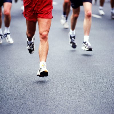 Marathon runners on road, low section
