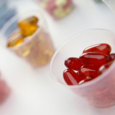 Close-up of an assortment of tablets and capsules in cups