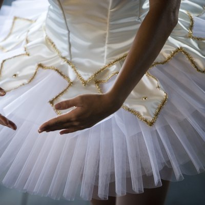 Midsection of a young woman practicing ballet dancing