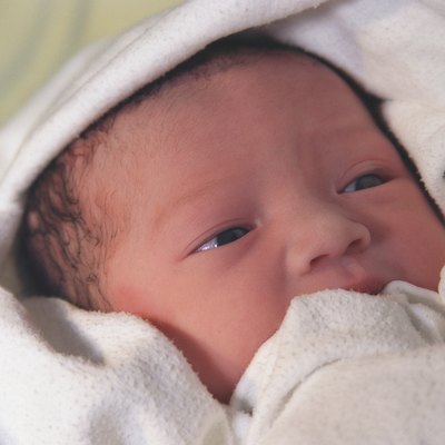 Newborn wrapped in white blanket