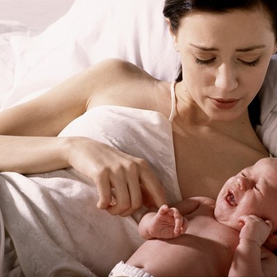 High angle view of a mother lying in bed with her son