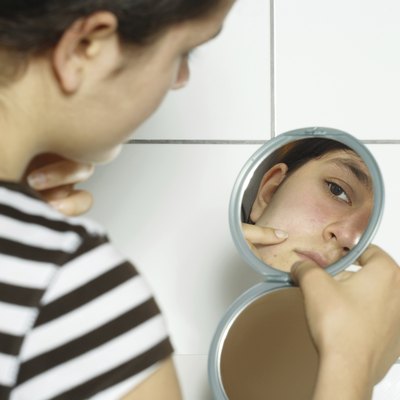Checking her blemishes