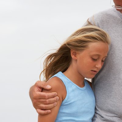 Man with arm round girl (10-11), waist up