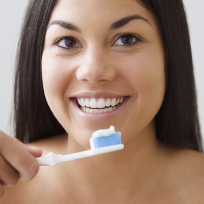Young woman brushing her teeth