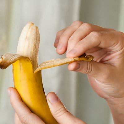 hands peeling a banana