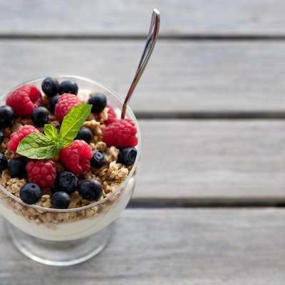 Cup of fresh fruits with cereals and yogurt.