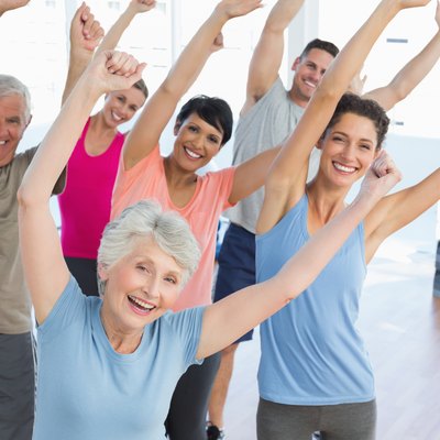 Portrait of smiling people doing power fitness exercise
