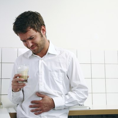 young man with coffee have stomachache