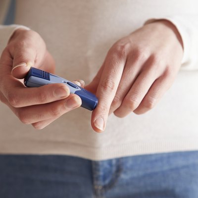 Female Diabetic Checking Blood Sugar Levels