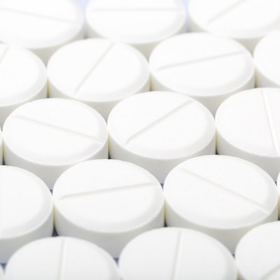 White pills on a white background
