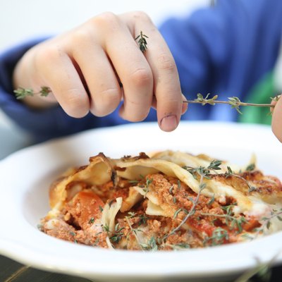 Boy preparing lasagna