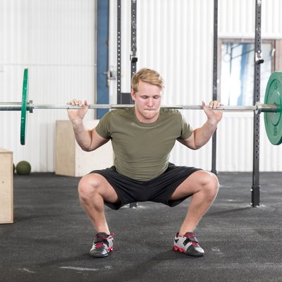 Squats training at fitness gym center