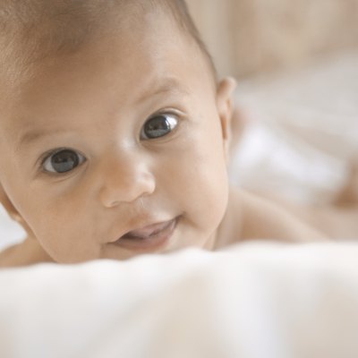 Close-up of a baby lying on a bed