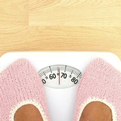 Woman watching her weight - detail, on scales
