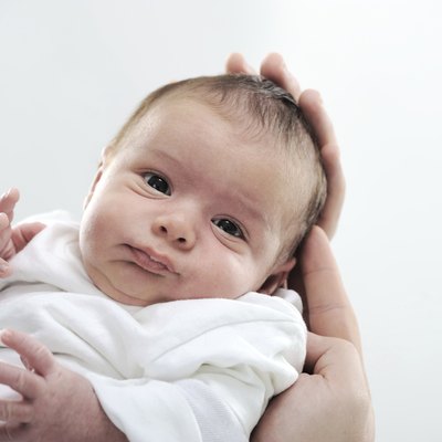 Newborn baby in mother's arms