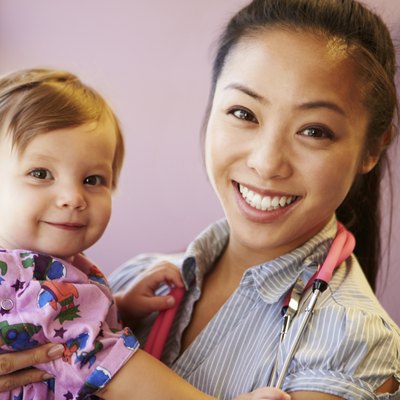 Young Girl Being Held By Female Pediatric Doctor