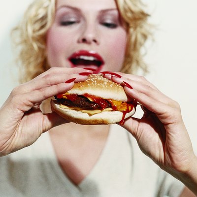 Young Woman Holding a Cheeseburger