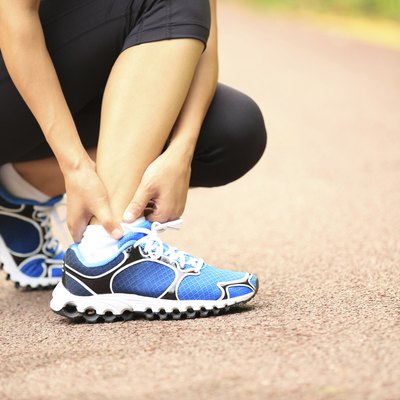 woman runner hold twisted ankle