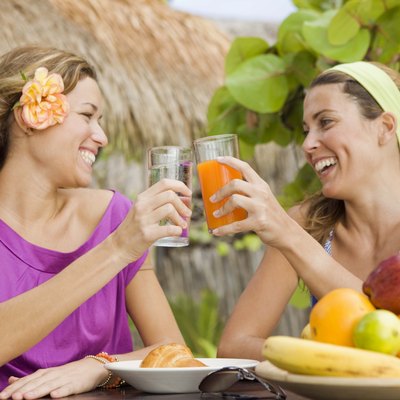 Women talking and having tropical fruit