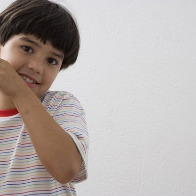 Boy (8-9) holding glass of milk, portrait