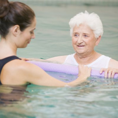 Instructor And Elderly Patient Undergoing Water Therapy