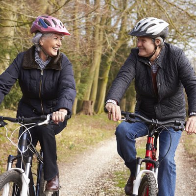 Senior Couple On Cycle Ride In Winter Countryside