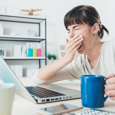 Tired woman at office desk
