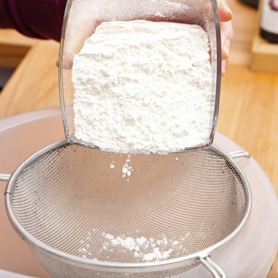 Put flour of glass bowl through a sieve