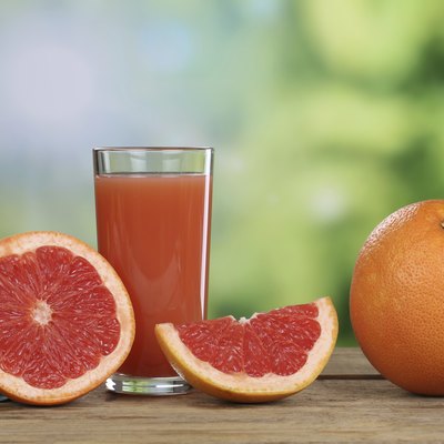 Grapefruit juice and fresh grapefruits in summer