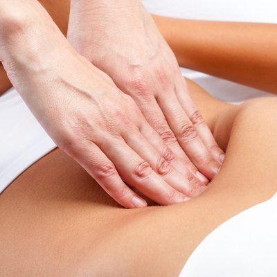 Therapist Hands pressing on female abdomen.