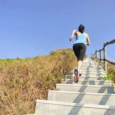 woman running up on mountain stairs