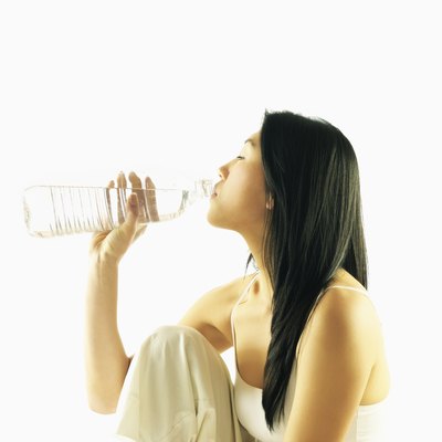 Side profile of a young woman drinking water