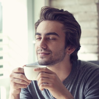 Young man drinking coffee in cafe