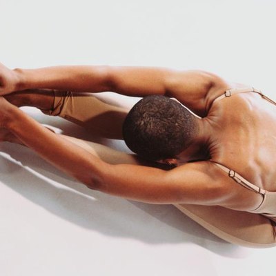 portrait of flexible person touching their toes
