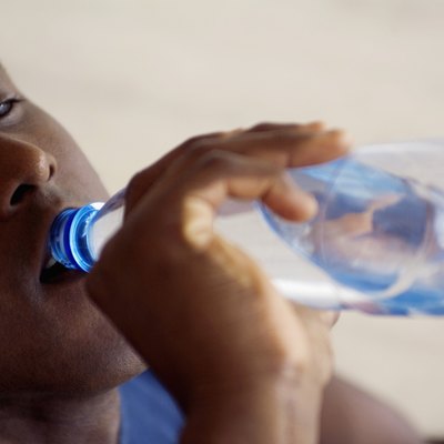 Man drinking bottled water, close-up