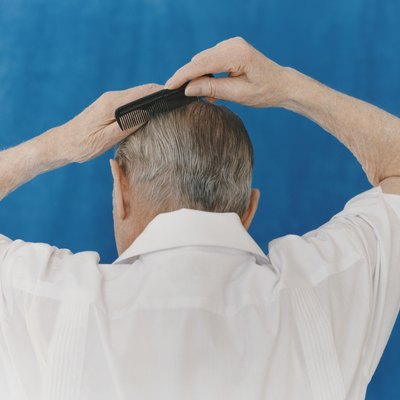 Rear View of a Senior Man Combing His Hair