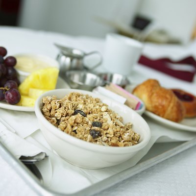 Close up of a breakfast tray lying on a bed