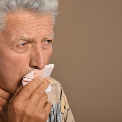 Sick old man on grey background