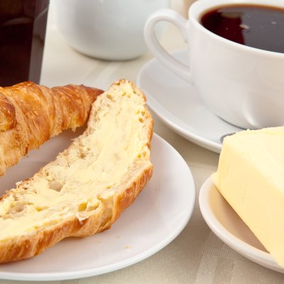 Breakfast with a croissant spread with butter