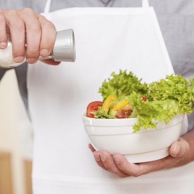 Salting salad.