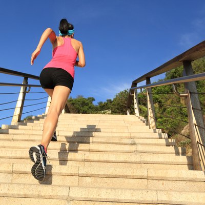 healthy lifestyle sports woman running up on stone stairs seaside