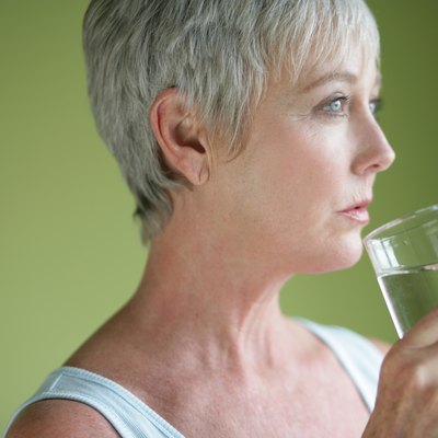 Mature adult with glass of water.