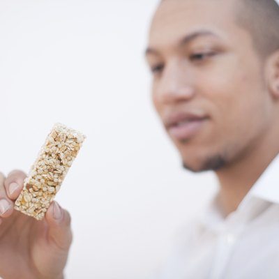 Young African-American Man Eating Cereal Bar