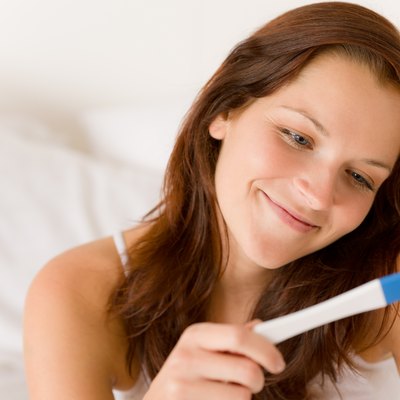 Pregnancy test - happy surprised woman