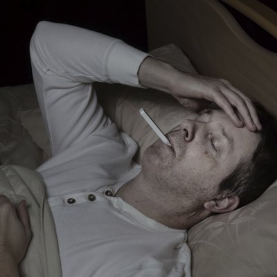 Mature man with high fever in bed