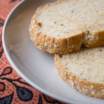 two slices of grain bread in white plate