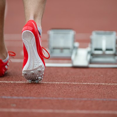 Professional sprinter walking towards starting line on running track