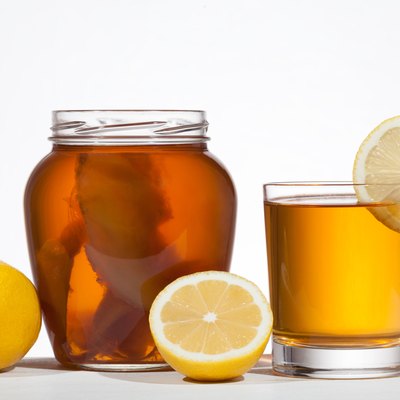 Kombucha super food pro biotic beverage in glass with lemon