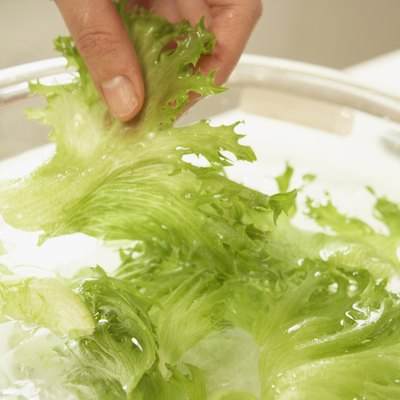 Woman making salad, close up
