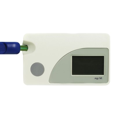 Blood glucose testing kit on white background